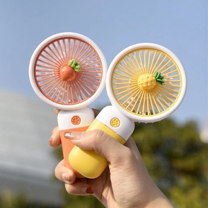 Portable mini handheld fan with cute cartoon carrot and pineapple designs for kids
