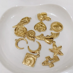 Collection of golden titanium steel charms including heart, wings and starfish shapes