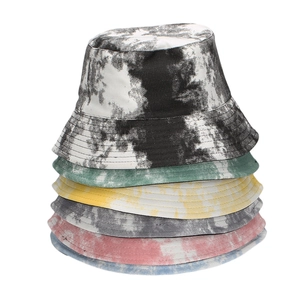 Stack of colorful tie-dye bucket hats in cotton twill for outdoor sun protection