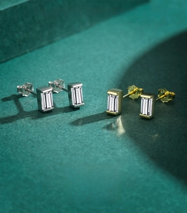 Close-up of baguette-cut zircon stud earrings in silver and gold 925 sterling silver