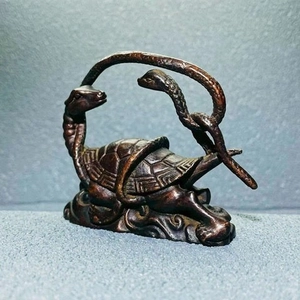 Macro detail of antique copper Black Tortoise Xuanwu figurine with shell textures