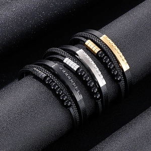 Detailed shot of multi-layer braided leather bracelets with stainless steel beads
