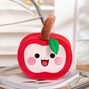 Close-up of red apple shaped bag with cartoon embroidery on an acrylic chair