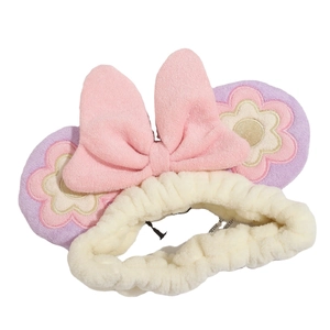 Cute plush headband with pink bow and floral embroidery for makeup and skincare