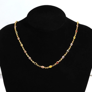 Detailed view of colorful marquise-cut zircons on a gold-plated copper necklace