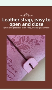 Close-up of pink leather A6 notebook with butterfly embossing and elastic band closure
