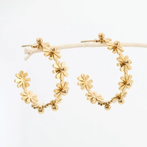 Detailed close-up of 18k gold plated stainless steel daisy floral C-shape hoop earrings