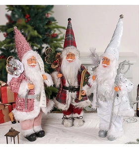 Detailed view of standing Santa Claus dolls in pink, plaid, and white sequin outfits