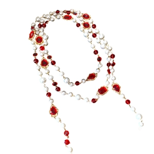 Vintage multi-layer pearl necklace with red gemstones and golden metallic accents