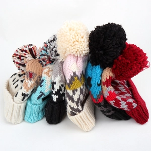 Thick winter knit beanies with colorful geometric patterns and large pom-poms on top