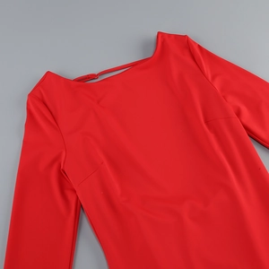 Detail of red backless dress showing crew neck strap and high-elastic knit fabric texture