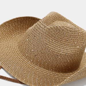Macro shot of tan straw fedora with gold sequins and dark woven chin strap detail