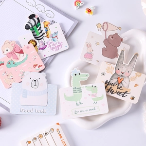 Detailed flat lay of cute animal paper gift cards with decorative English phrases