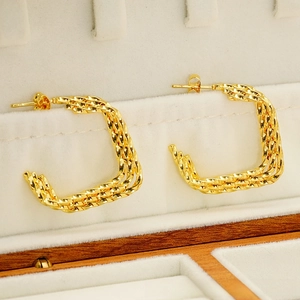 Detail of 18K gold plated multi-layer twisted rope C-shaped hoop earrings in a jewelry box