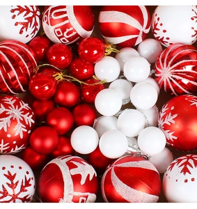 Detailed overhead view of red and white Christmas balls with glitter snowflake patterns