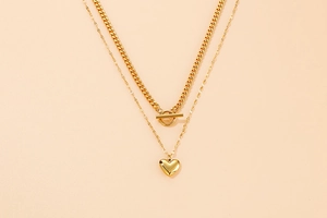 Detail of double-layer gold titanium necklace with OT buckle and heart pendant