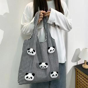 Detail of checkered canvas tote bag with five cute 3D panda plush toy decorations
