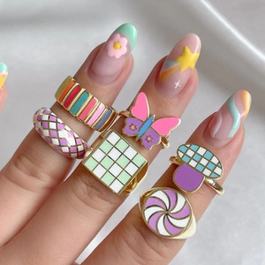 Detailed close-up of colorful enamel alloy rings with striped and butterfly patterns