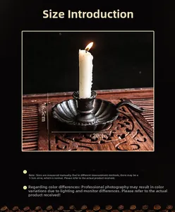 Close-up of vintage cast iron candle holder with petal base and side handle on wood