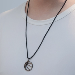 Men's black basketball pendant necklace with bead chain shown on a male model