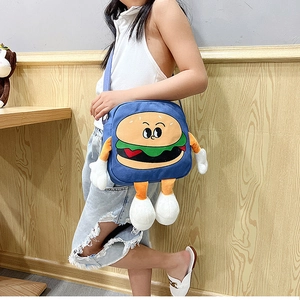 Blue canvas crossbody bag featuring a 3D cartoon burger design worn by a model