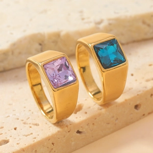 Macro shot of gold stainless steel rings with purple and blue square-cut gemstones