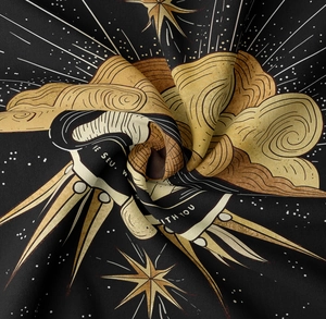 Macro detail of sun and moon tapestry fabric showing woven texture and gold print