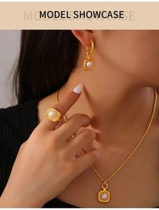 Polished gold jewelry set featuring fresh water pearls worn by model in detail