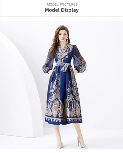 Detail of V-neck wrap dress featuring gold baroque prints and sheer lantern sleeves