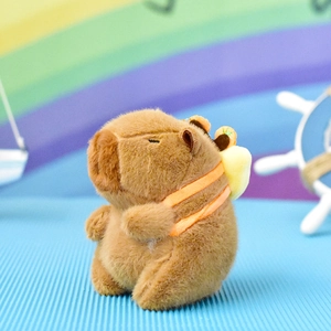 Adorable brown capybara plush keychain with a small yellow backpack on a rainbow background