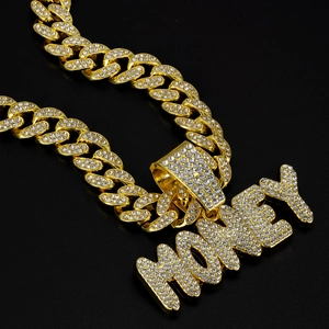 Detail of gold Cuban chain and large iced-out MONEY letter pendant with rhinestones