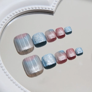 Aurora aurora press-on toenails set featuring glitter blue and pink gradient textured designs
