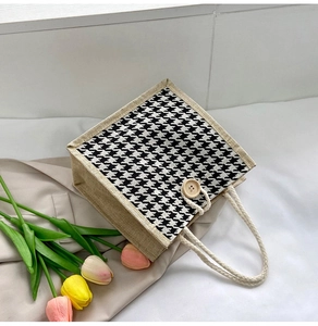 Detail of canvas tote bag featuring houndstooth pattern and natural hemp rope handles