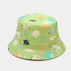 Detail shot of light green bucket hat with cartoon fish patterns and cotton texture