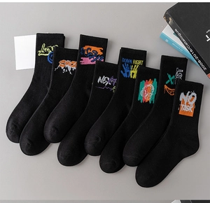 Detail of black crew socks with colorful street graffiti and vibrant letter prints