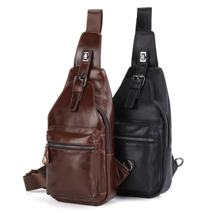 Close-up of leather chest bags in brown and black with metal zippers and buckles