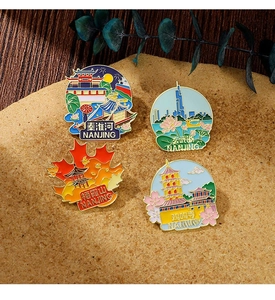 Set of four Nanjing landmark enamel pins with temple and river motifs on yellow background