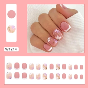 Short matte pink French press-on nails with white flower patterns and gold foil flakes