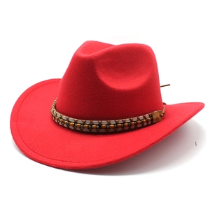 Detailed view of red felt cowboy hat with ethnic beaded band and leather buckle
