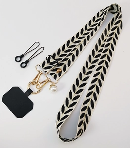 Crossbody phone strap with leaf pattern, gold hooks, pearl charm and black tether pad