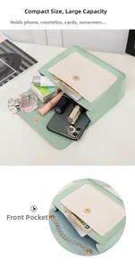 Detail view of mint green crossbody bag interior storage and functional front pocket
