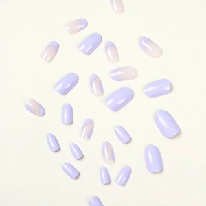 Short almond press-on nails featuring purple French wave designs and solid lavender tones
