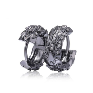 Macro detail of gunmetal hoop earrings with zircon stones and feather texture design