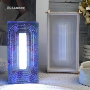 Detail of trapezoid resin mold and glowing night light lamp with geometric texture