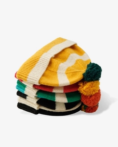 Detail of colorful striped knitted beanies with pom-poms in various layered color options