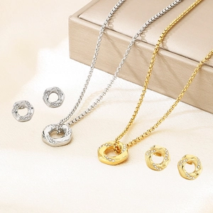 Detail view of 18K gold and silver plated stainless steel jewelry sets on silk cloth