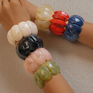 Close-up of chunky marble texture acrylic stretch bracelets in multiple vibrant colors
