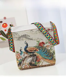 Detailed close-up of peacock jacquard embroidery and colorful woven shoulder strap