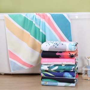 Absorbent quick-dry beach towels with colorful rainbow stripes and tropical prints