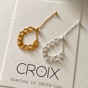 Detail of minimalist adjustable chain rings in gold and silver finishes on display card